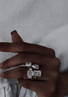 a woman's hand with three rings on it