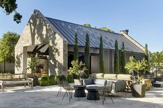 an outdoor patio with chairs, tables and potted plants