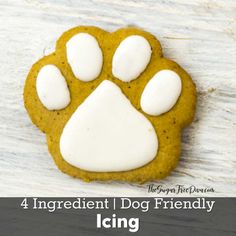 a dog paw cookie with white frosting on it and the words, 4 ingredient dog friendly icing