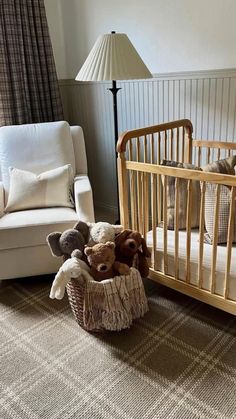 there is a crib with stuffed animals in it and a chair next to it