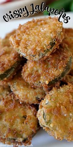 some fried food on a white plate with the words crispy jalapenos