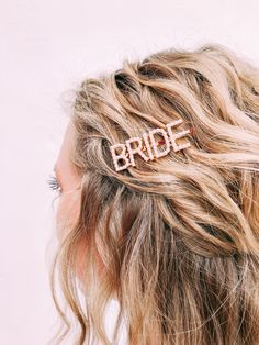 a bride hair comb with the word bride written on it in rose gold metal letters