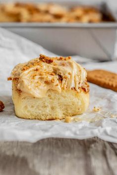 a close up of a pastry with icing and cinnamon crumbs on it