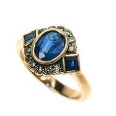 This STUNNING Vintage Inspired ring has been crafted from 9ct Solid Gold. A bezel set HUGE Oval cut NATURAL Sapphire brings this ring to life along with two Vibrant Square cut NATURAL Sapphires resting on the shoulders adding additional appeal to this exquisitely feminine ring. Surrounding the face of this GORGEOUS ring are GENUINE Diamonds which have been claw set. This Victorian inspired ring must be seen to be truly appreciated. This ring will add an exotic vintage appeal to any lady who appr Diamond Ring Vintage, The Bling Ring, Vintage Inspired Rings, Victorian Ring, Antique Diamond Rings, Vintage Sapphire, Ruby Emerald, Victorian Rings, Anniversary Jewelry