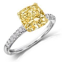 This fine canary diamond engagement ring features a GIA certified 1.20 Ct. Fancy Yellow Cushion cut diamond with VS2 clarity. Round cut diamonds (.25 ctw.) are placed down the shank in U-setting. split Metal : 14K Two Tone, 18K Two Tone, Solid Platinum/18K Yellow Gold Setting Type : U-Pave, Prong Total Carat Weight : 1.45 Carats Type : Natural Genuine Diamond Shape : Cushion Cut Carat Weight : 1.20 Ct. (GIA Certified) GIA Certification : Included Measurement : Contact us for a copy of GIA certif Canary Diamond Engagement Ring, Two Tone Engagement Rings, Cushion Cut Solitaire, Yellow Diamond Ring, Canary Diamond, Yellow Cushion, Cushion Cut Diamond Ring, Ring Cuts, Engagement Rings Sale