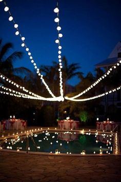 an outdoor pool decorated with christmas lights