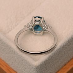 This ring features a 7mm*9mm oval cut genuine London blue topaz and sterling silver finished with rhodium. Customization is available. It is made by hand, and it will take about 7 days to finish the ring after your payment is completed. Main stone: London blue topaz London blue topaz weight: Approx 2.00 ct Metal type: sterling silver finished with rhodium Accent stone: cz Customization is available, I also can make it with 14k solid gold (white or yellow or rose) and diamond accent stone, just f Topaz Rings, Etsy Engagement Rings, Blue Gemstone Rings, Spinel Ring, Yellow Gemstones, London Blue Topaz Ring, Pear Engagement Ring, Citrine Ring, November Birthstone