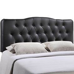 a black headboard with white pillows on it