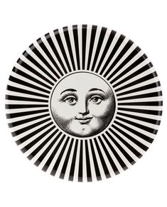 a black and white plate with a sun face