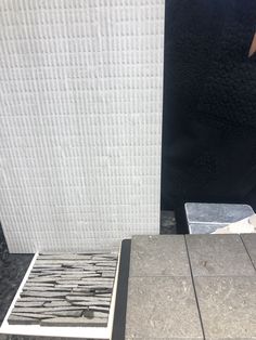 there is a piece of tile that has been placed on the ground next to it