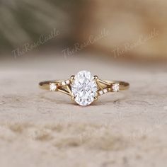 a close up of a ring with a diamond in it on a stone surface and the background is blurry