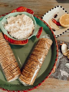 there are two plates with food on them and one plate has some crackers in it