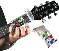 a man is playing an electric guitar with colorful buttons on the frets and strings