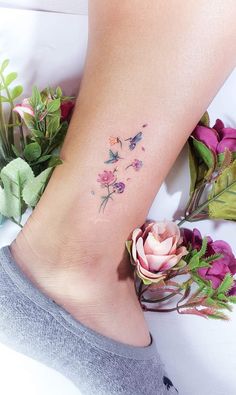 a woman's foot with flowers on it