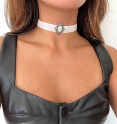 Bring out your inner gothic royalty with this luxe velvet choker, featuring a victorian style pendant hand sewn in the center. DETAILS  * Velvet Ribbon Width: 5/8" (just over 1/2 inch) * Stainless Steel closure * Choose between 11.5", 13", and 15" * Contains a 3" extender so you can adjust to your preference *model wears 11.5" 💌 Message me for custom lengths :) KNOWING YOUR SIZE: You can use a measuring tape to measure the center of you neck. Don't have a measuring tape? Grab a thread or ribbon and wrap around the neck, mark the ribbon, and measure it against a ruler. KEEP IN MIND that there is a 3" extension chain that you can adjust as well :) Find Nude/Champagne Color here: https://www.etsy.com/listing/499637782/victorian-chokervelvet-chokernude-color?click_key=9cba5afbc7a7221cb3f78a9a Elegant Jewelry For Cosplay, Gothic White Choker Jewelry, White Gothic Choker Jewelry, Elegant Adjustable Jewelry For Cosplay, Silver Choker For Cosplay, Gothic Choker For Formal Occasions, Gothic Royalty, Regency Core, Victorian Choker