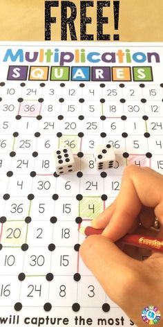 a person is writing on a board with numbers and dices in front of it