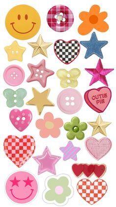 a bunch of different types of buttons on a white surface with stars, hearts, and smiley faces