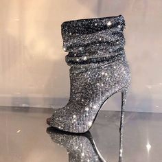 Step out in style with our Silver Strass Hotfix Slouch Boots! Featuring a peep toe design, stiletto heel, and dazzling embellishments, these booties are a must-have for fashion-forward individuals. Color: Silver Heel Type: Stiletto heel Heel Height: 4.5" / 115 mm approx Product measurements were taken using size 8. Please note that measurements may vary by size. Toe: Peep toe All-over rhinestone embellishment Handcrafted US sizing. Fits true to size. Glamorous Open Toe Fitted Boots, Fitted Glamorous Open Toe Boots, Glamorous Fitted Open Toe Boots, Glamorous Open Toe Party Boots, Silver Fitted Heels With Bling, Fitted Silver Heels With Bling, Silver Bling Heels With Fitted Design, Silver Heels With Bling, Glamorous Silver Evening Boots