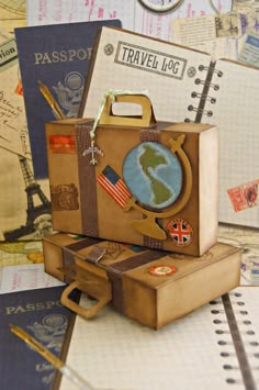 an open suitcase sitting on top of a table next to other travel related items and papers