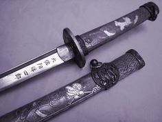 two swords with writing on them sitting next to each other in front of a purple background