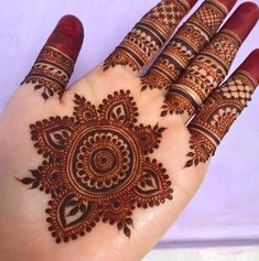 the hand is decorated with henna designs on it