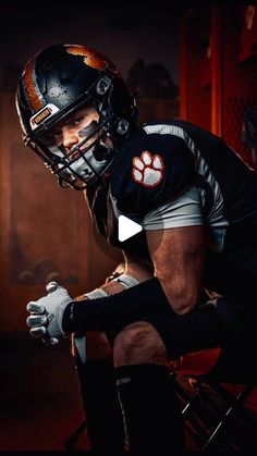 a football player sitting in a chair with his foot on the ground and wearing a helmet