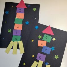 two pieces of paper cut out to look like rockets and stars on black paper with the words rocket above them