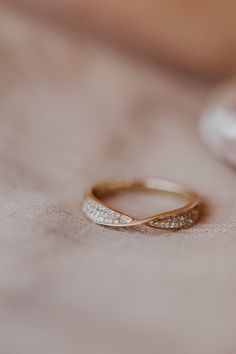 a close up of a gold ring with diamonds on the inside and in the outside