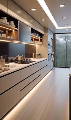 a modern kitchen with white cabinets and wood flooring is lit by recessed lighting