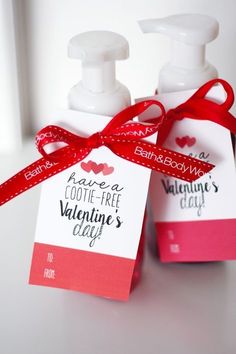 two hand soaps with red ribbon tied around them on a white countertop next to a card that says, have a footie - free valentine's day