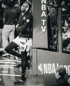 a man standing on top of a basketball court in front of a sign that says n b a v