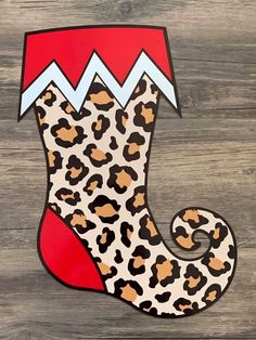 an animal print christmas stocking on a wooden background