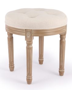 a round wooden stool with a white cushion on it's top and two legs