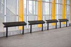 three benches are lined up against the wall