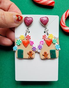 🏠 Embrace Whimsical Charm: Handmade Polymer Clay Gingerbread House Earrings 🏠 Step into a world of enchantment with these captivating handmade polymer clay gingerbread house earrings! Each pair is meticulously crafted to capture the magic of a cozy gingerbread house, adorned with a miniature gingerbread man, delicate hand-painted icing trims, a charming little heart, and a roof that's as sweet as a swirl of confectionery delight. These delightful earrings are a festive accessory that will add Polymer Clay Gingerbread House, Clay Gingerbread House, Gingerbread House Earrings, Polymer Clay Christmas Earrings Gingerbread Man, Gingerbread Accessories, Gingerbread Jewelry, Polymer Clay Gingerbread, Gingerbread Earrings, Clay Gingerbread