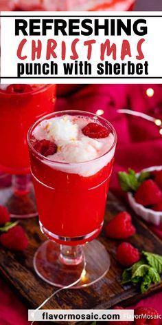 two glasses filled with red liquid and topped with whipped cream, raspberries and mint leaves