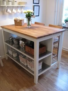 a kitchen island with shelves and baskets on it