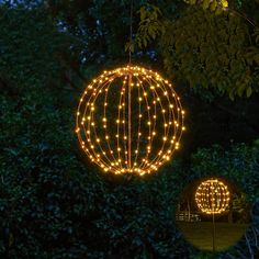 an outdoor decoration with lights in the shape of a ball and a sphere on it