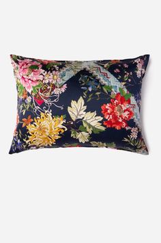 an image of a floral pillow on a white background with blue and pink flowers in the middle