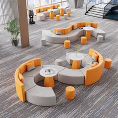 an office lobby with circular seating and tables