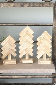 three wooden blocks sitting on top of a table next to a vase filled with flowers