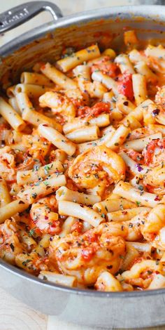 pasta with shrimp and tomato sauce in a skillet on the stove top, ready to be eaten