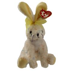 a white stuffed animal with a red heart on it's head and ears, sitting in front of a white background