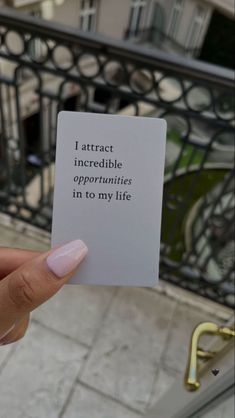 a person holding up a piece of paper that says i attract incredible opportunity in my life