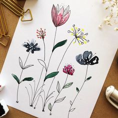 some flowers are painted on a piece of paper