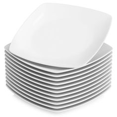 a stack of white plates stacked on top of each other in front of a white background