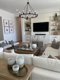 a living room filled with furniture and a flat screen tv mounted to the side of a wall