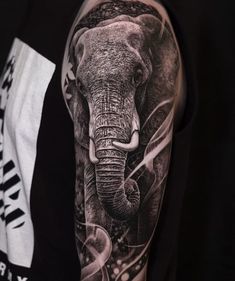 an elephant tattoo on the arm and shoulder