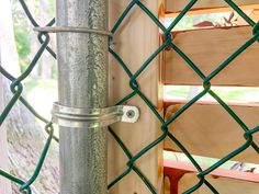 a close up of a metal pole on a chain link fence