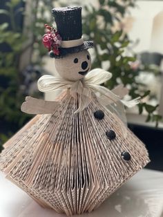 an origami snowman made out of book pages